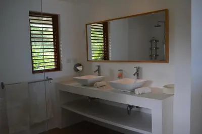 a bathroom with two sinks and a mirror at Villa Noria in Las Terrenas