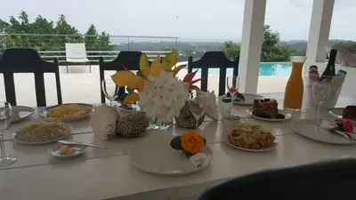 a white table with plates of food on it at Villa Noria in Las Terrenas