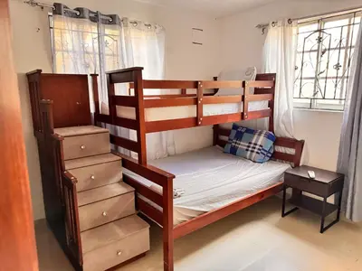 a bedroom with two bunk beds and a window at 1Dom Rep - Huge cozy 3 bedrooms - close to all transportation Jacobo Majluta - Residencial Paradise V Colina Arroyo 1 in Santo Domingo