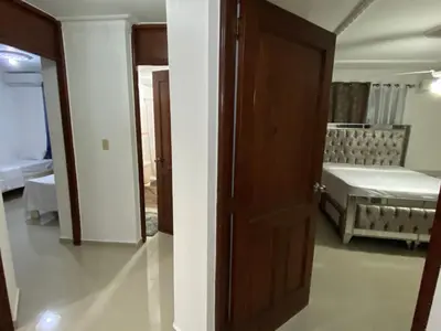 an open door to a room with a bedroom at 1Dom Rep - Huge cozy 3 bedrooms - close to all transportation Jacobo Majluta - Residencial Paradise V Colina Arroyo 1 in Santo Domingo