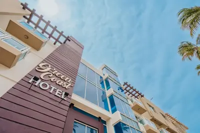 a view of the front of a hotel with palm trees at Hotel Checkin El Cortecito in Punta Cana