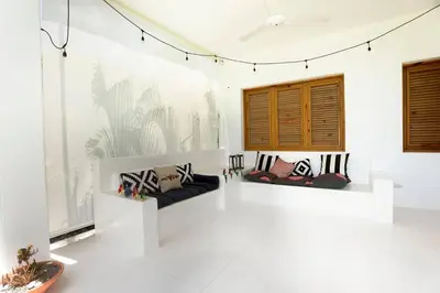 a white room with two couches on a wall at Villa Kalfu with AC in Las Galeras