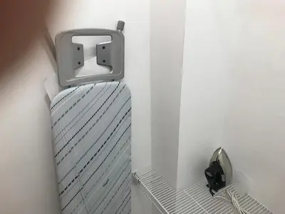 a metal radiator in a white wall with a metal holder at CONFORTABLE first floor en santiago RD in Santiago de los Caballeros