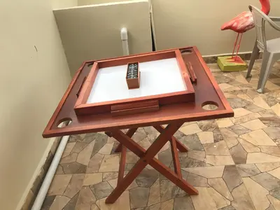 a wooden table with a remote control on top of it at moderno apto frente a la piscina in Santiago de los Caballeros