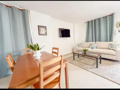 a living room with a table and a couch at Fully Equipped New 2br Aptdt2mins To The Beach in Sosúa