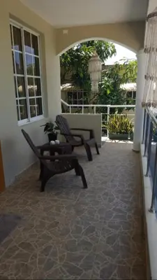 a living room with a couch and a table at Fully Equipped New 2br Aptdt2mins To The Beach in Sosúa