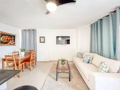 a living room with a white couch and a table at Fully Equipped New 2br Aptdt2mins To The Beach in Sosúa