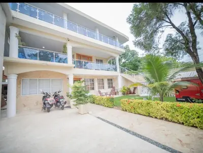 two motorcycles parked in front of a building at Fully Equipped New 2br Aptdt2mins To The Beach in Sosúa