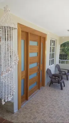 a room with a wooden door and a bench at Fully Equipped New 2br Aptdt2mins To The Beach in Sosúa