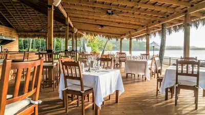 a dining room with tables and chairs in a pavilion at Cap el Limon Luxury Villas in El Limón