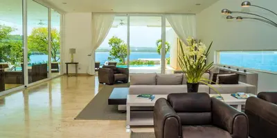 a living room with a couch and chairs and a table at Cap el Limon Luxury Villas in El Limón