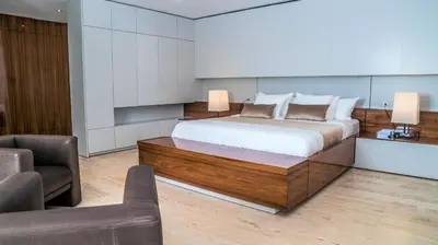 a bedroom with a large bed and a couch at Cap el Limon Luxury Villas in El Limón