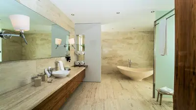 a bathroom with a large mirror and a tub and a sink at Cap el Limon Luxury Villas in El Limón