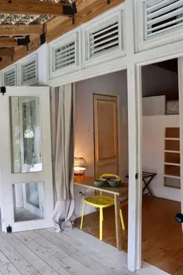 a room with a table and a room with a door at Bungalow with pool and Air Conditioning near playa Macao in Punta Cana