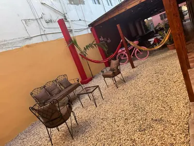 a group of chairs sitting outside of a building at Hotel Loro Tuerto in Santa Cruz de Barahona