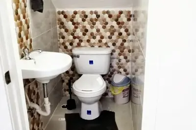 a bathroom with a toilet and a sink at Spacious house in Santo Domingo Este with garden in Santo Domingo