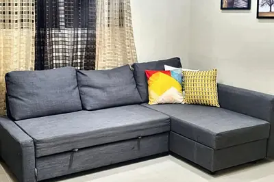 a gray couch with pillows in a living room at Spacious house in Santo Domingo Este with garden in Santo Domingo