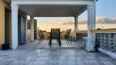 a patio with a table and chairs on a balcony at Spacious house in Santo Domingo Este with garden in Santo Domingo