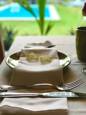 a table with a napkin with a fork and knife at PUNTA POPY BOUTIQUE HOTEL - Adults Only in Las Terrenas