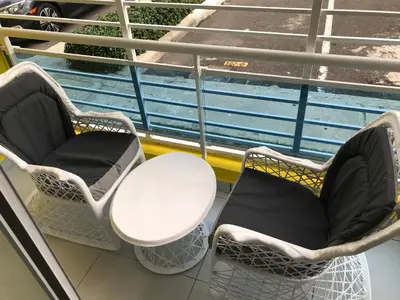 two chairs and a table on a balcony at cómodo first floor in Santiago de los Caballeros