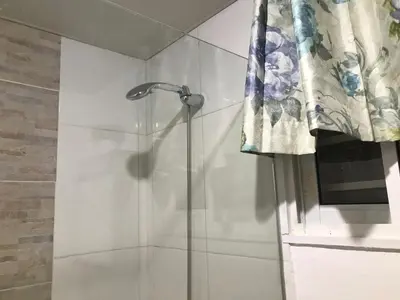 a shower with a shower head in a bathroom at cómodo first floor in Santiago de los Caballeros