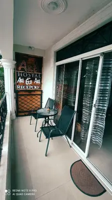 a balcony with two chairs and a table on a porch at Private Rooms-Art Punta Cana in Punta Cana