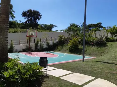 a basketball hoop in a yard with a fence at Paraiso de verano in Santiago de los Caballeros