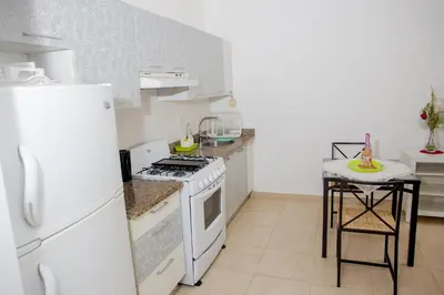 a kitchen with a white stove and a white refrigerator at Bela Villa Apartment IDA in Bayahibe