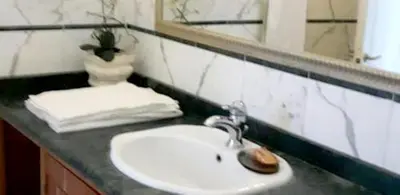 a bathroom counter with a sink and a mirror at Sea View Apartment in Boca Chica, 50 m², Air Conditioning in Boca Chica