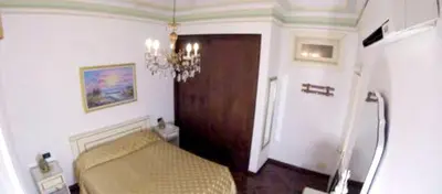 a bedroom with a couch and a wooden door at Sea View Apartment in Boca Chica, 50 m², Air Conditioning in Boca Chica