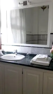 a bathroom counter with a sink and a mirror at Sea View Apartment in Boca Chica, 50 m², Air Conditioning in Boca Chica