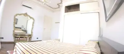 a bedroom with a large bed and a mirror at Modern Apartment in Boca Chica, 130 m², Air Conditioning Included in Boca Chica
