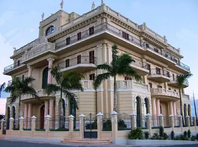 a large building with palm trees in front of it at Modern Apartment in Boca Chica, 130 m², Air Conditioning Included in Boca Chica