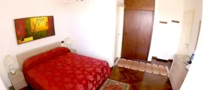 a bedroom with a red bed in a room at Modern Apartment in Boca Chica, 130 m², Air Conditioning Included in Boca Chica