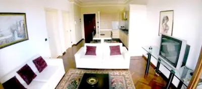 a living room with a couch and a television at Modern apartment in Boca Chica – 75 m² with air conditioning in Boca Chica