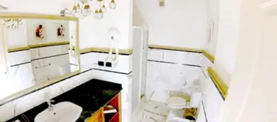a white bathroom with a sink and a toilet at Modern apartment in Boca Chica – 75 m² with air conditioning in Boca Chica