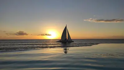 a sail boat in the ocean at sunset at Million View Room Adults Only Resort 1 in La Laguna