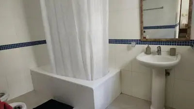a bathroom with a shower curtain and a sink at Million View Room Adults Only Resort 1 in La Laguna