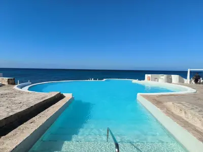 a swimming pool with the ocean in the background at Million View Room Adults Only Resort 1 in La Laguna