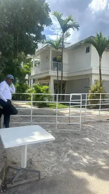 a man sitting on a bench in front of a building at Million View Room Adults Only Resort 1 in La Laguna