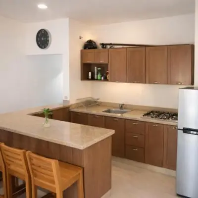 a kitchen with wooden cabinets and a counter top at Espectacular Apartamento con Vista al Mar Solo Adultos in La Laguna