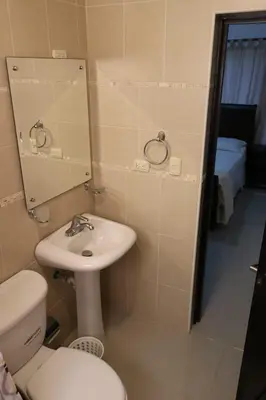 a bathroom with a sink and a toilet and a mirror at Apartamento Amueblado Amplio Tranquilo Privado Como tu lo Mereces in Santiago de los Caballeros