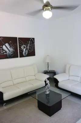 a living room with two white couches and a coffee table at Apartamento Amueblado Amplio Tranquilo Privado Como tu lo Mereces in Santiago de los Caballeros