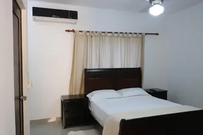 a bedroom with a bed and a window at Apartamento Amueblado Amplio Tranquilo Privado Como tu lo Mereces in Santiago de los Caballeros