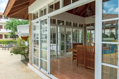 a house with glass doors and a patio at Hotel Silvestre in La Romana
