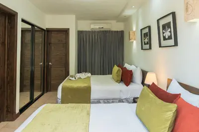 a hotel room with two beds and a window at Hotel Silvestre in La Romana