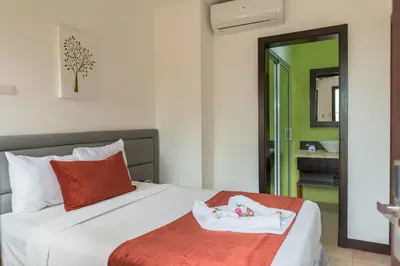 a bedroom with a bed and a bathroom with a mirror at Hotel Silvestre in La Romana