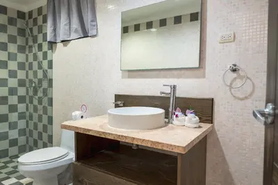 a bathroom with a sink and a toilet at Hotel Silvestre in La Romana