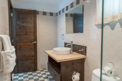 a bathroom with a sink and a toilet and a mirror at Hotel Silvestre in La Romana