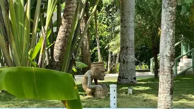 a statue of an elephant sitting in a park at La Cotica Casa Verde o Casa Azul in Las Terrenas